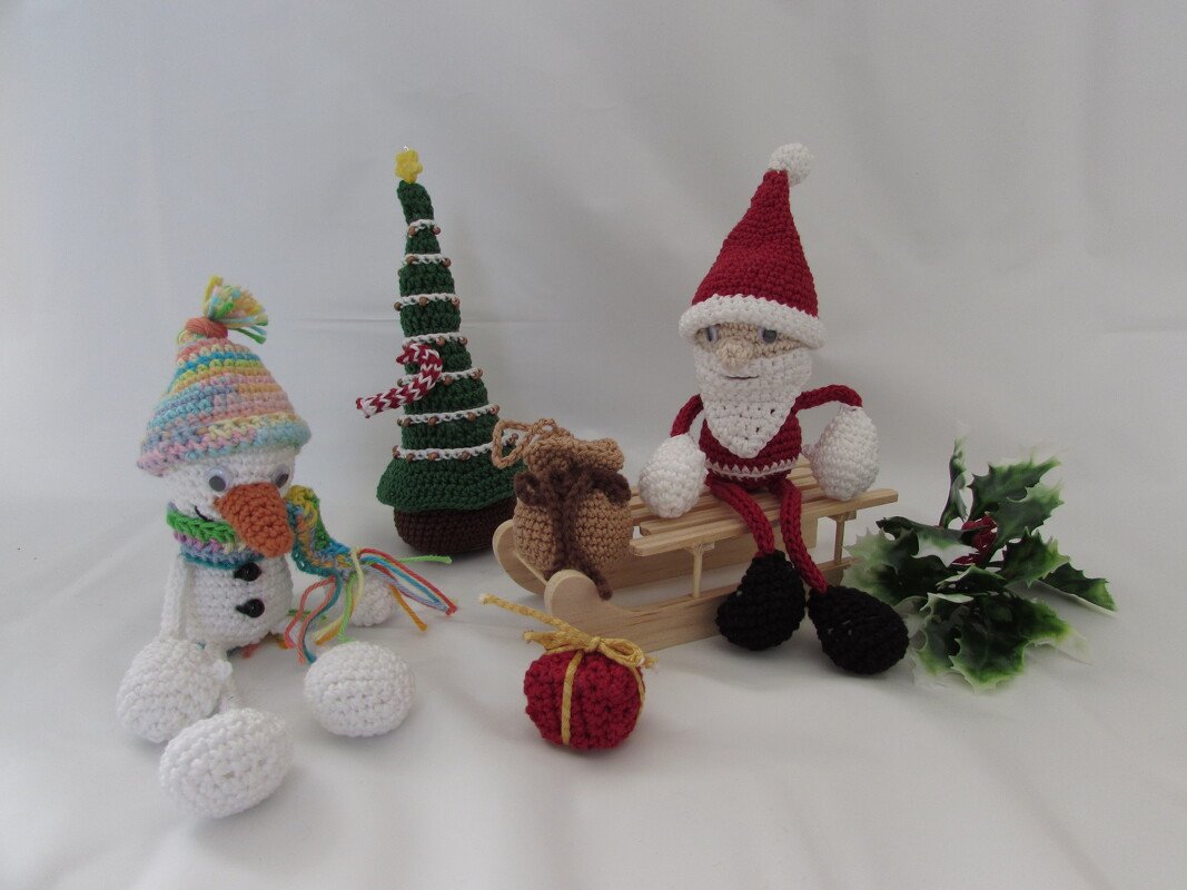 Gehäkeltes Miniatur-Ensemble: Nikolaus auf Schlitten, Schneemann, Tannenbaum und kleine Geschenkdekoration