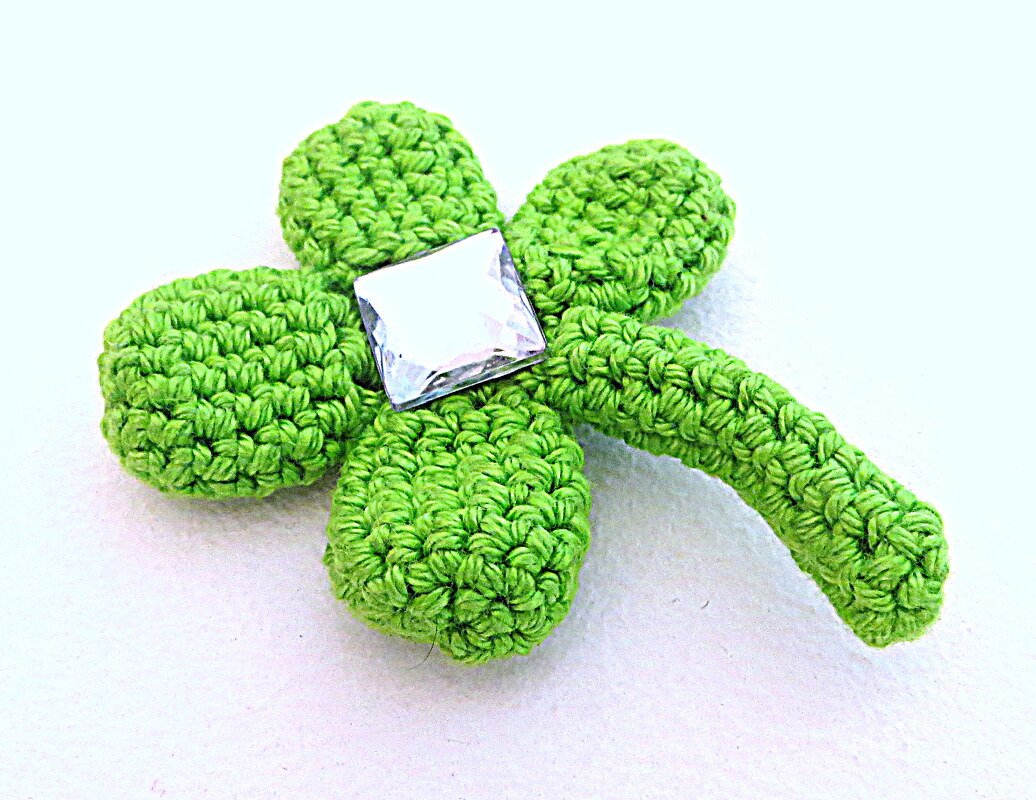 Gehäkeltes vierblättriges Kleeblatt in Grün mit quadratischem Schmuckstein