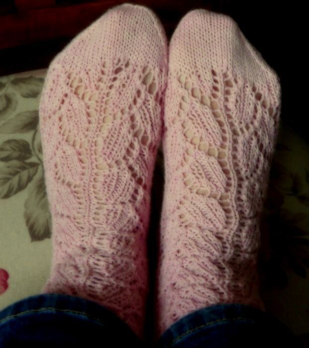 Detailaufnahme rosa gestrickter Socken mit sichtbar ausgearbeitetem Blatt-Ajourmuster