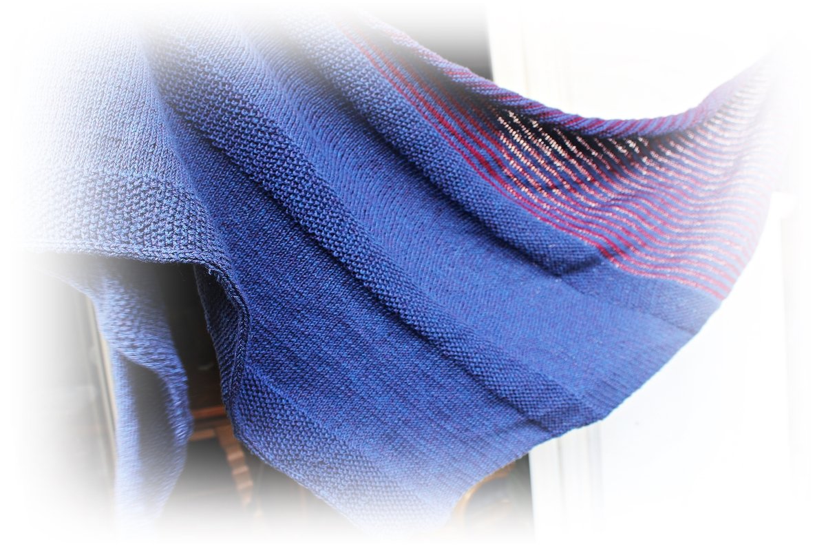 Close-up of blue knit scarf with textured stitches and thin red stripes