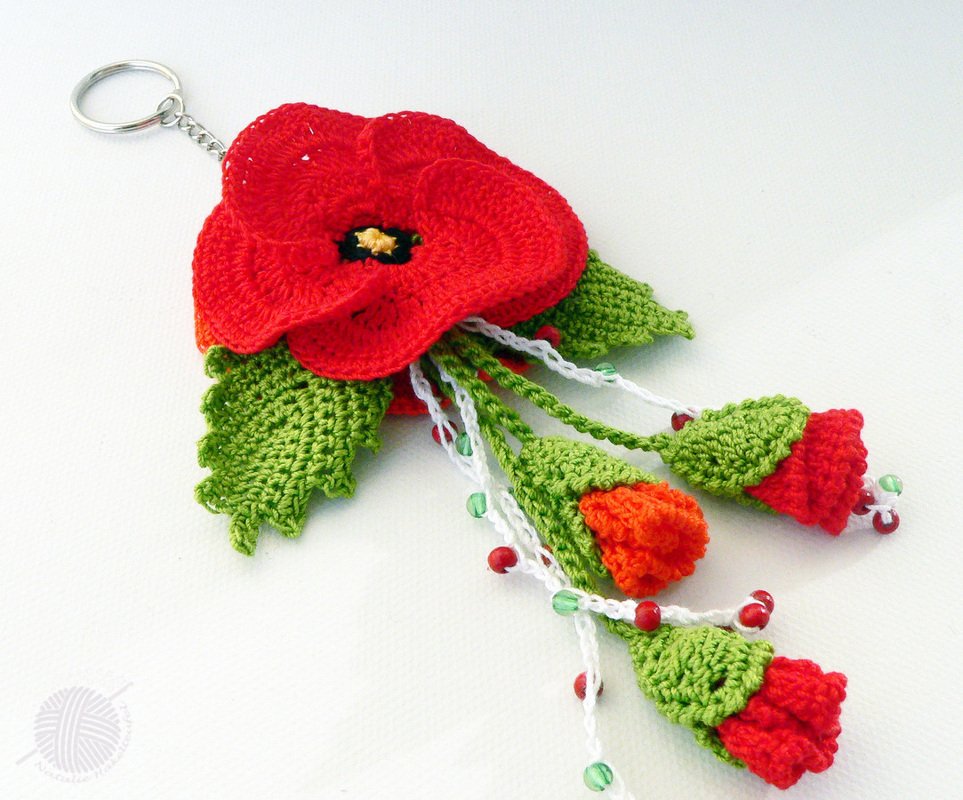 Compact crochet poppy keyring with scalloped leaves, braided cords and beads