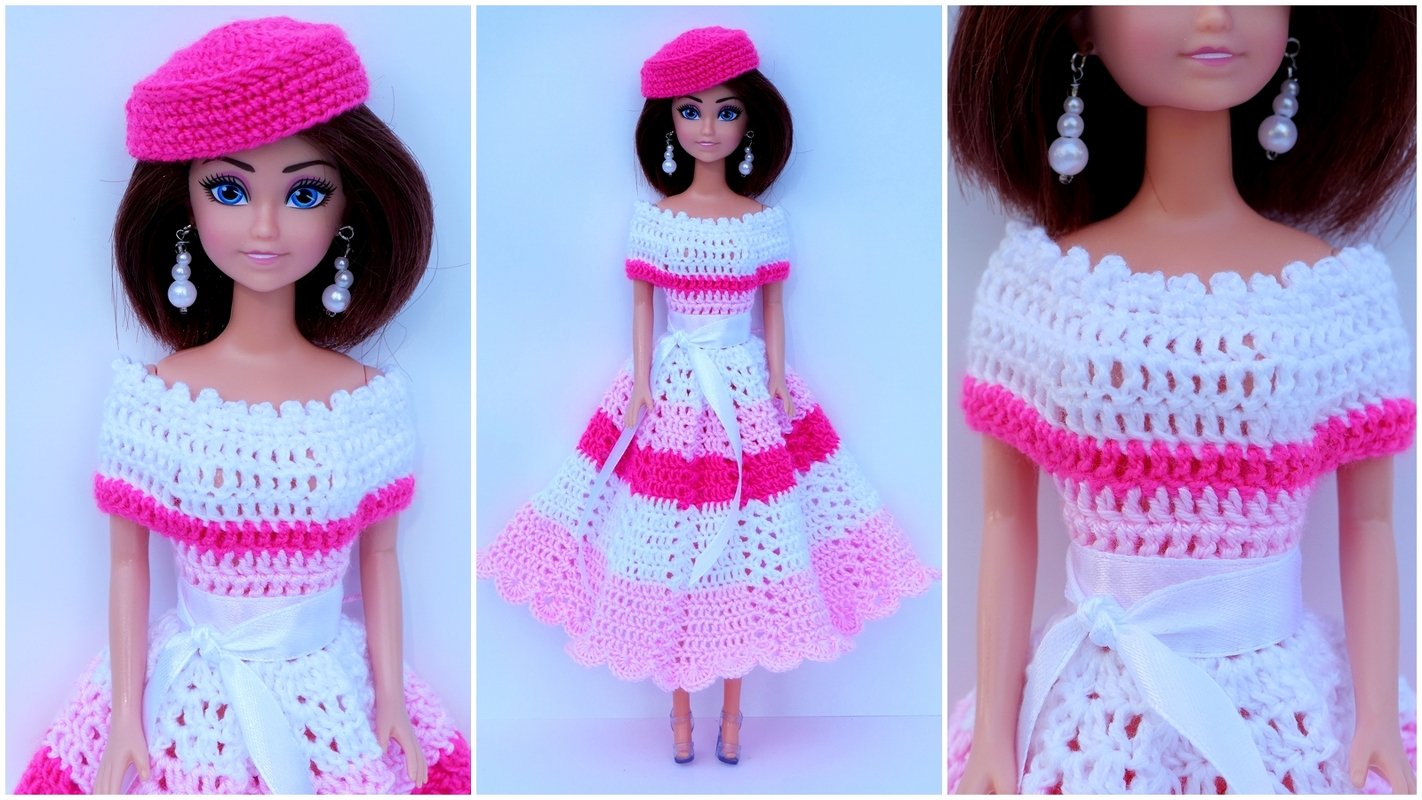 Doll wearing a crocheted pink and white off-the-shoulder dress and a pink beret.