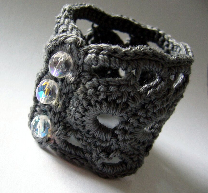 Dark gray crocheted cuff bracelet with three clear faceted beads