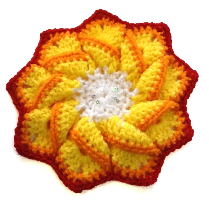 rund gehäkelte Applikation in Gelb und Orange mit weißem Zentrum