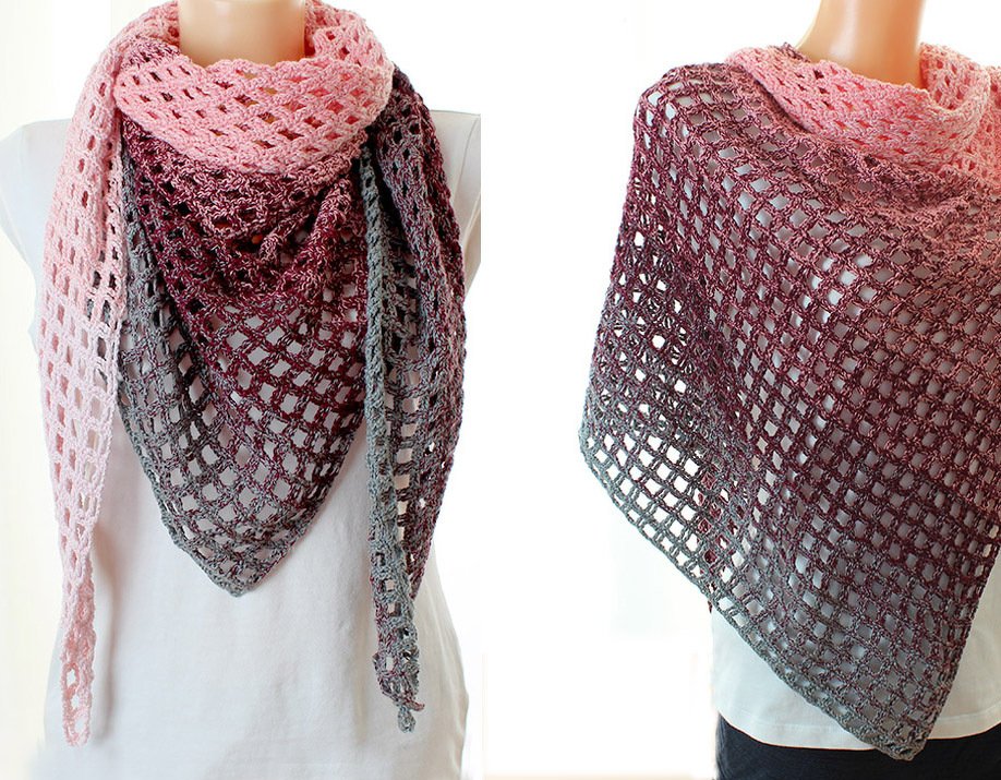 Pink-to-grey ombre crocheted triangle shawl with open mesh stitch on a mannequin.