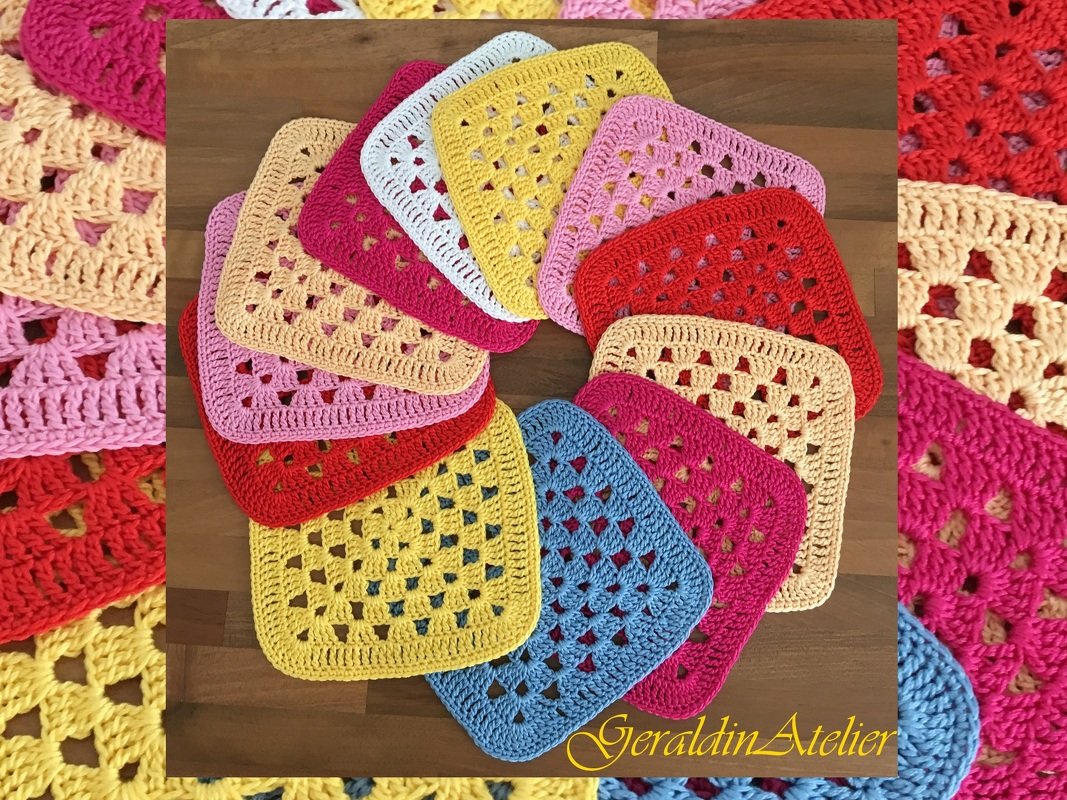 Bunte gehäkelte Granny Squares in verschiedenen Farben auf Holz angeordnet
