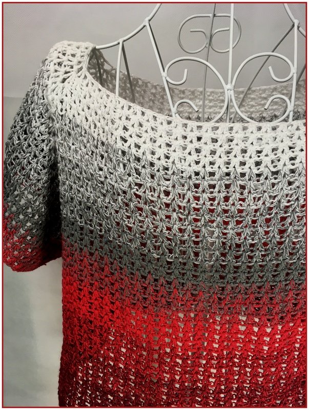 Open-lace crochet women's pullover in white, grey and red gradient on a wire mannequin