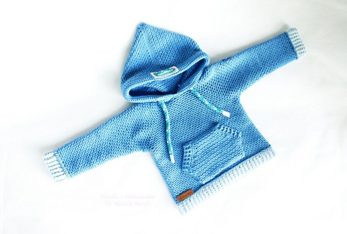 Light blue crocheted baby hoodie sweater with hood, pocket, and ribbed trim laid flat