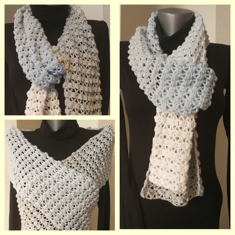 Hellblau-creme-weißer gehäkelter Schal mit Lochmuster auf Schaufensterpuppe