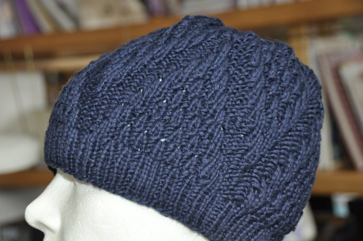 Nahaufnahme dunkelblaue Strickmütze mit Zopfmuster