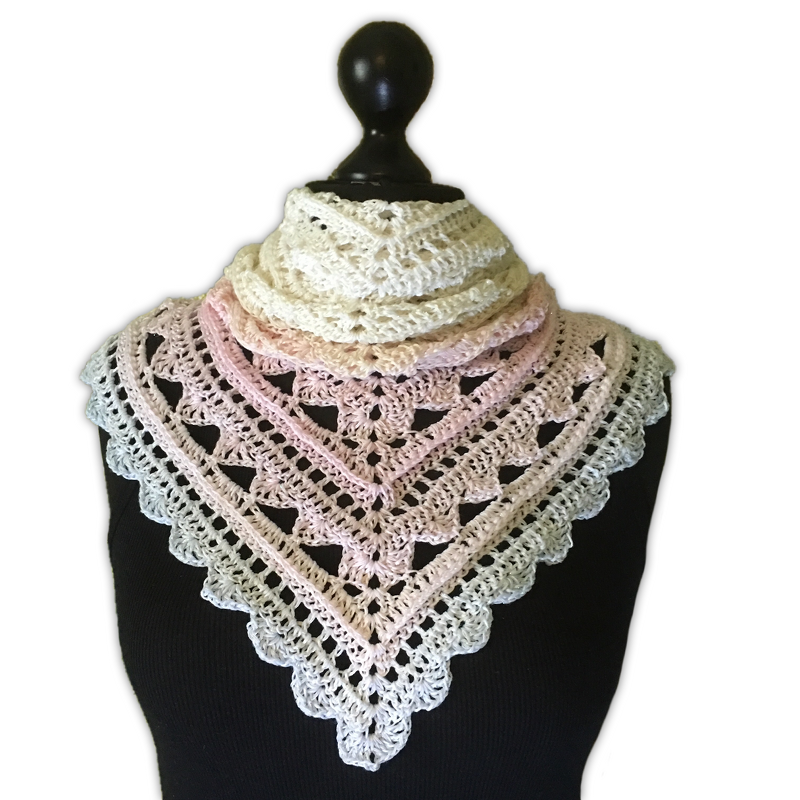 Pastel gradient crocheted triangle shawl on black mannequin