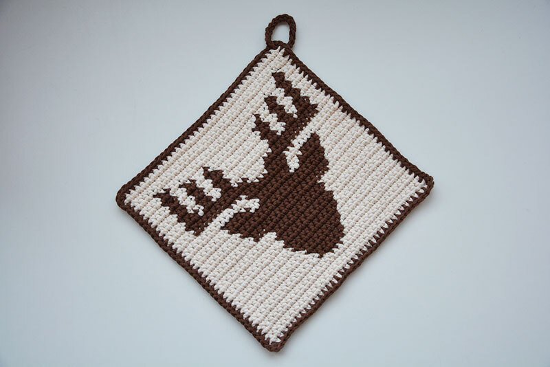 Quadratischer gehäkelter Topflappen in Creme mit braunem Hirschkopf und Aufhängeschlaufe