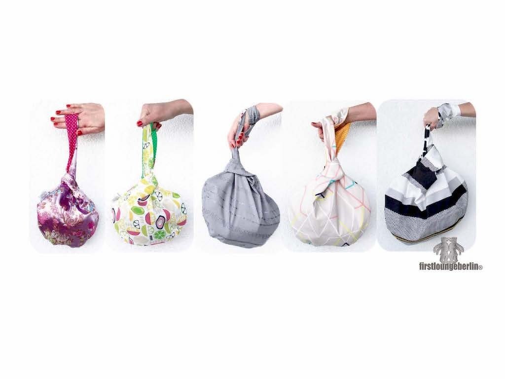 Runde Stoff-Knotentasche mit kurzem Tragegriff in neutralen und bunten Mustern