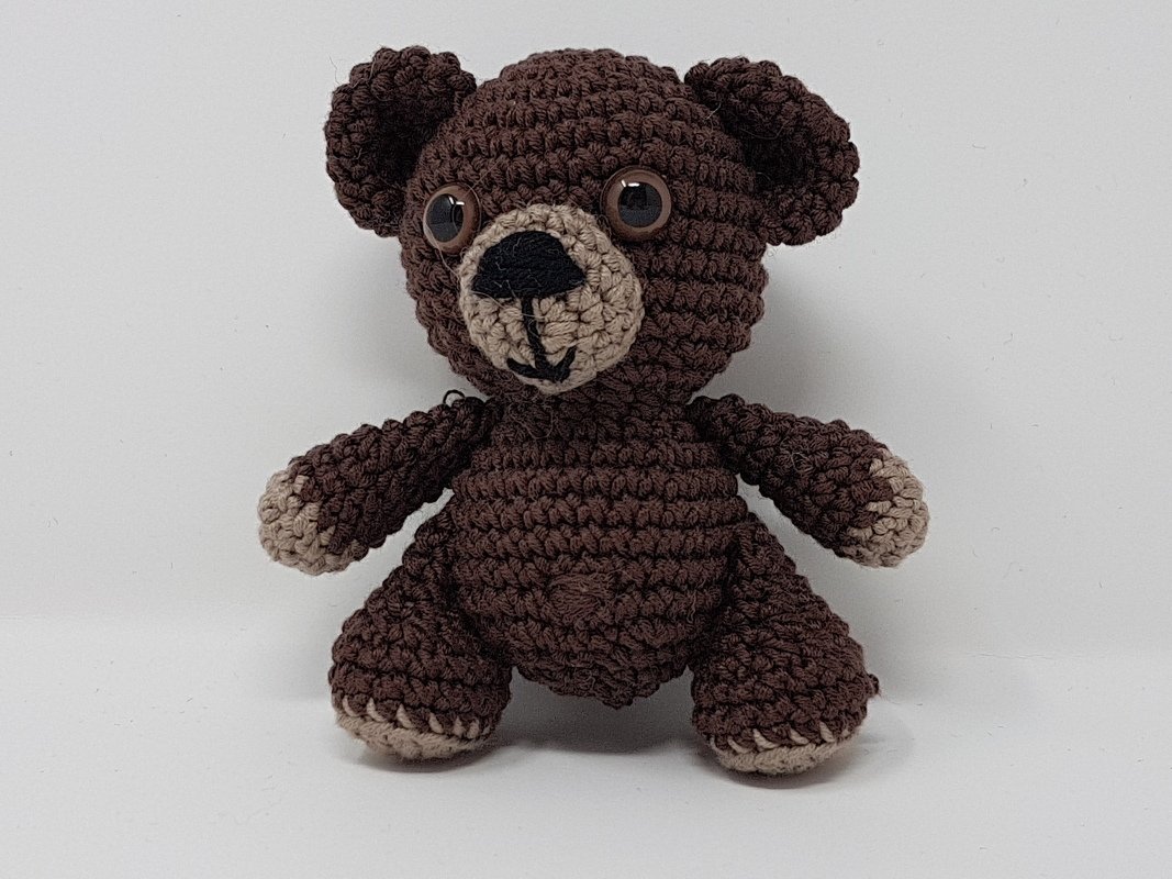 Kompakter brauner Amigurumi-Teddybär mit abgesetzter Schnauze und Pfoten