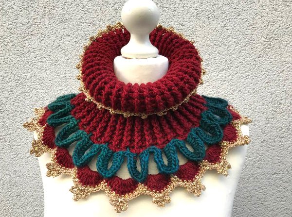 Gehäkelter Kragenschal in Bordeaux mit petrolfarbenen Rüschen und goldener Zierkante auf Schaufensterpuppe