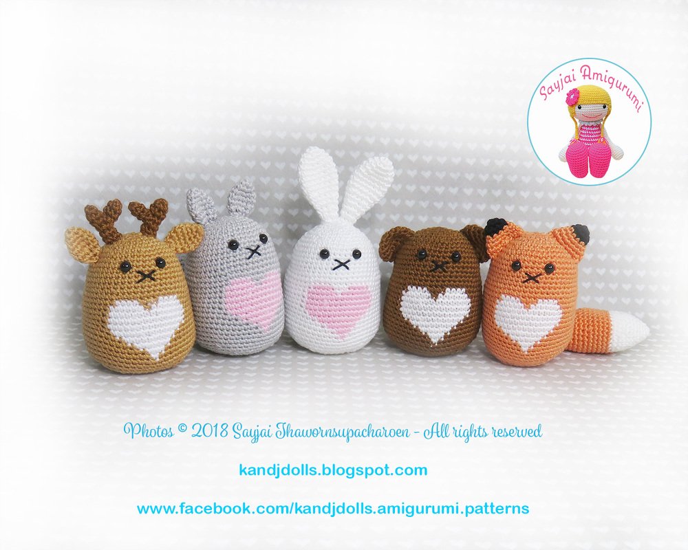 Front view of five crocheted amigurumi animals highlighting ear shapes, antlers and a heart-shaped belly motif.