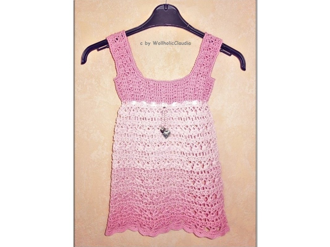 Gehäkeltes rosa Mädchenkleid mit Ombré-Farbverlauf an Kleiderbügel
