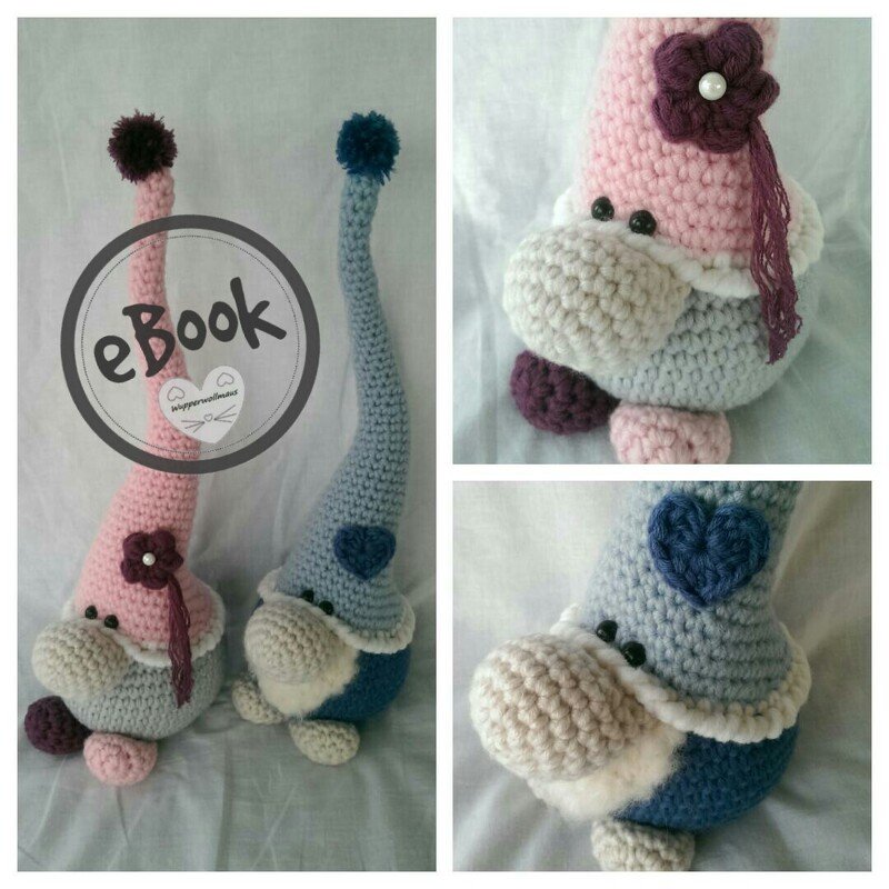 Two crocheted gnome doorstoppers in pink and blue with tall hats and pom-poms