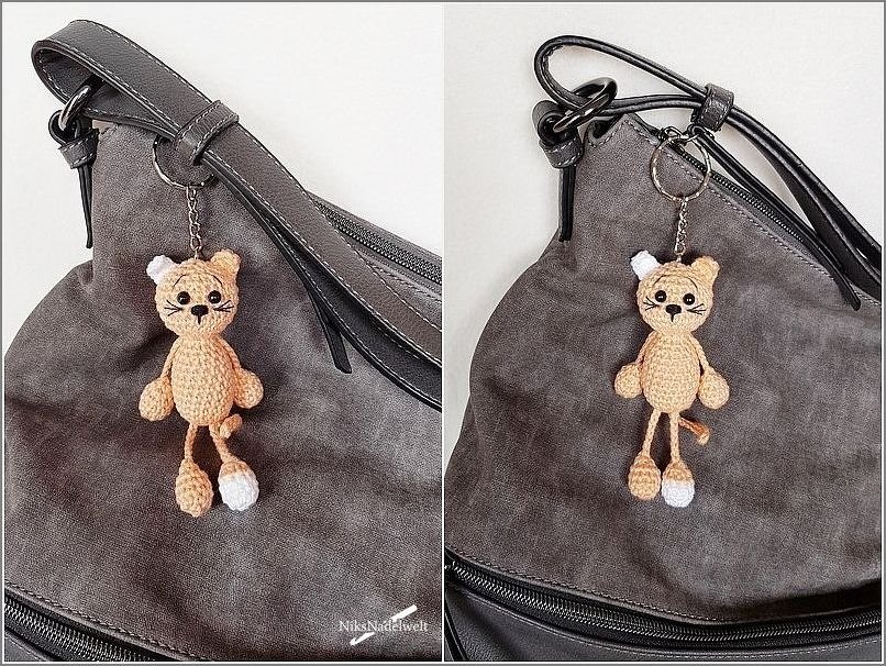 Gehäkelter Amigurumi-Katzen-Schlüsselanhänger an grauer Tasche