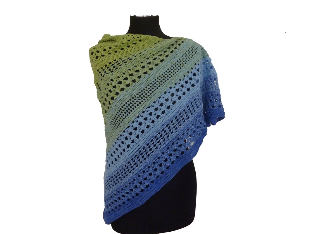 Gehäkeltes Dreieckstuch mit grün-blauem Farbverlauf und Lochmuster auf schwarzer Büste