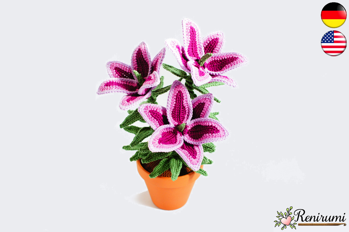 Crocheted fuchsia and pink lily flowers in an orange terracotta pot.
