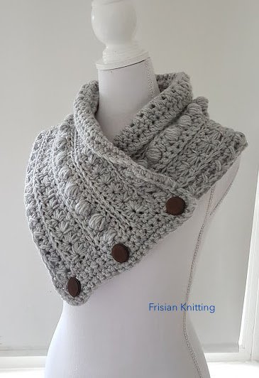 Light gray chunky crochet collar scarf with three dark buttons on a white mannequin