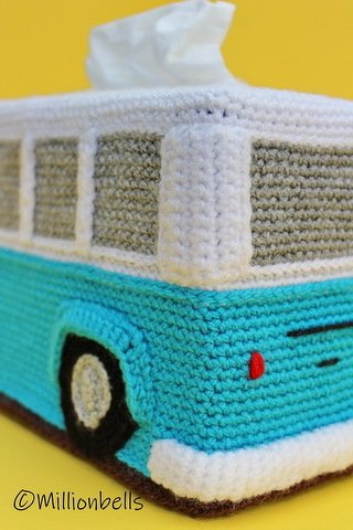Turquoise and white crocheted camper van tissue box cover with a tissue emerging from the top.