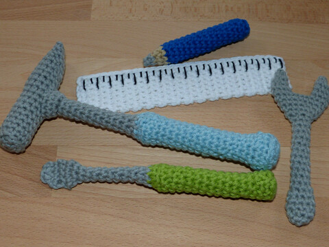 Crochet pattern tools: hammer, screwdriver, wrench, ruler, pencil