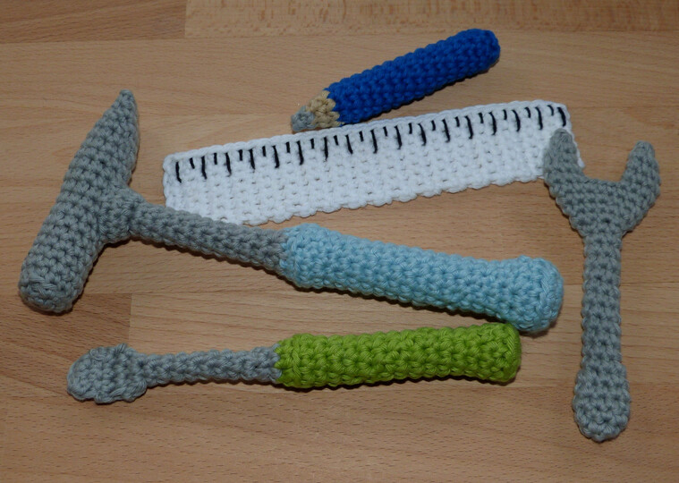Crochet pattern tools: hammer, screwdriver, wrench, ruler, pencil
