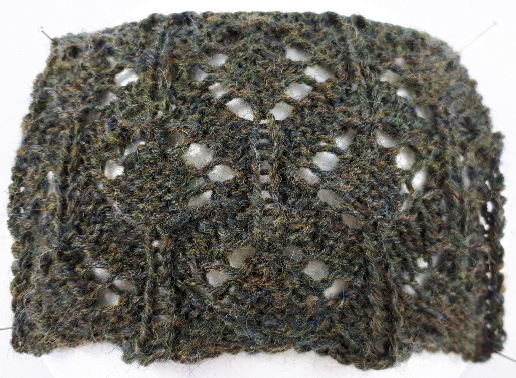 Gestricktes Spitzenprobestück in moosgrün mit Lochmuster und senkrechten Rippen