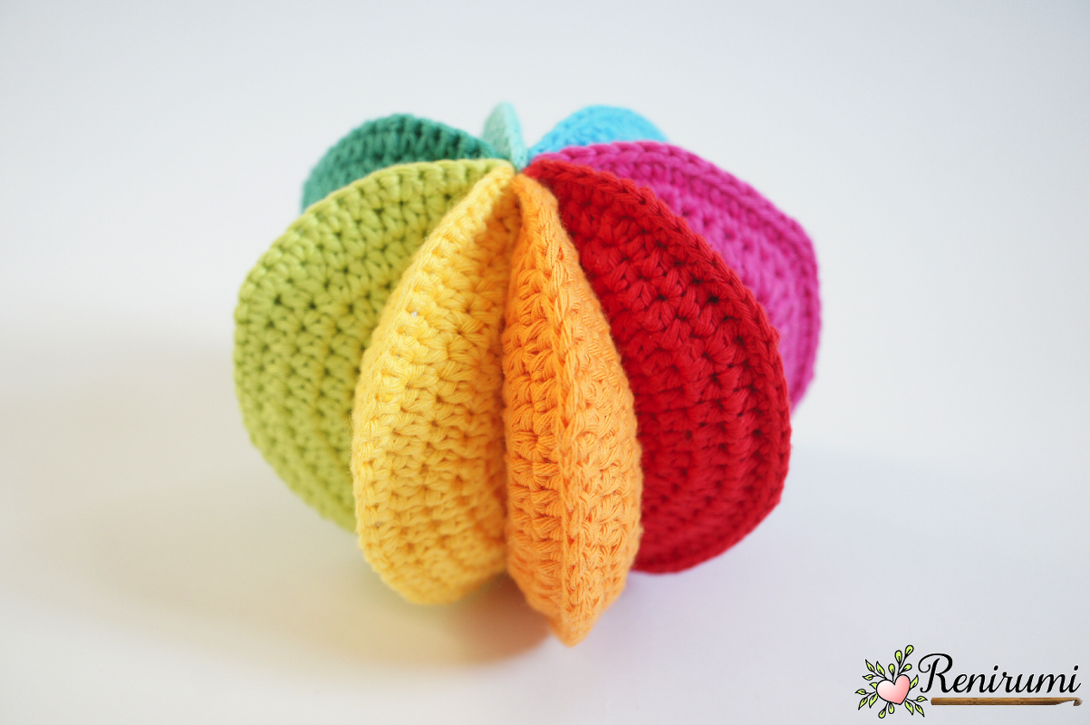 multicolored crocheted baby ball with petal-like stitched panels