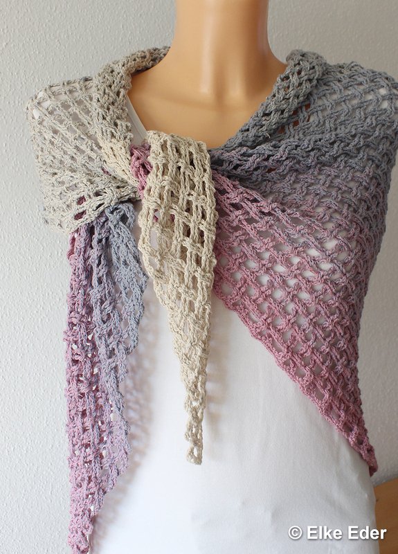 Open-mesh crochet triangle shawl in beige, gray and dusty rose draped on a mannequin