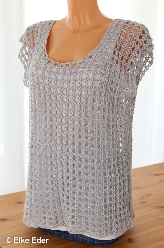 Light grey crochet openwork tunic with scoop neck on mannequin