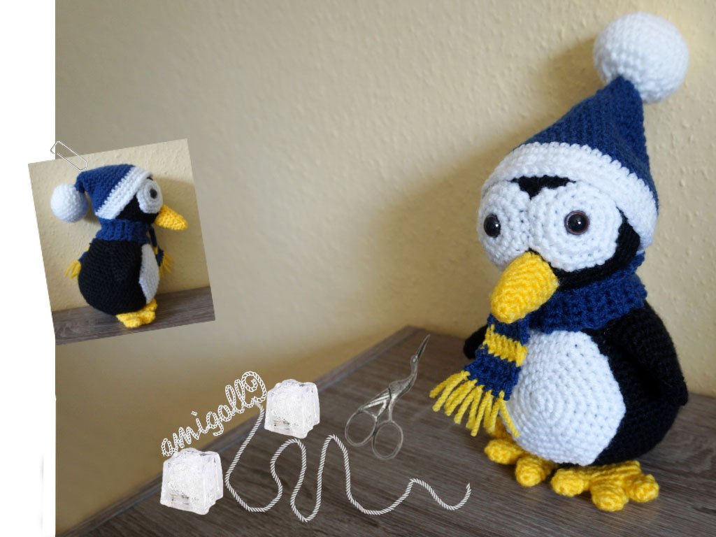 Crocheted amigurumi penguin wearing a blue-and-white pompom hat and a blue-and-yellow striped scarf.