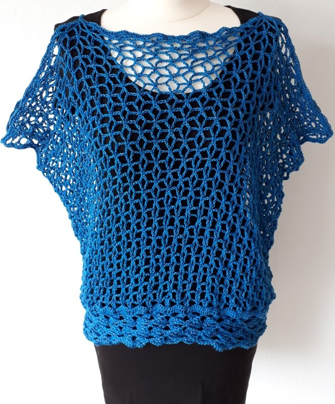 Blue crochet openwork short-sleeve tunic on mannequin over black slip