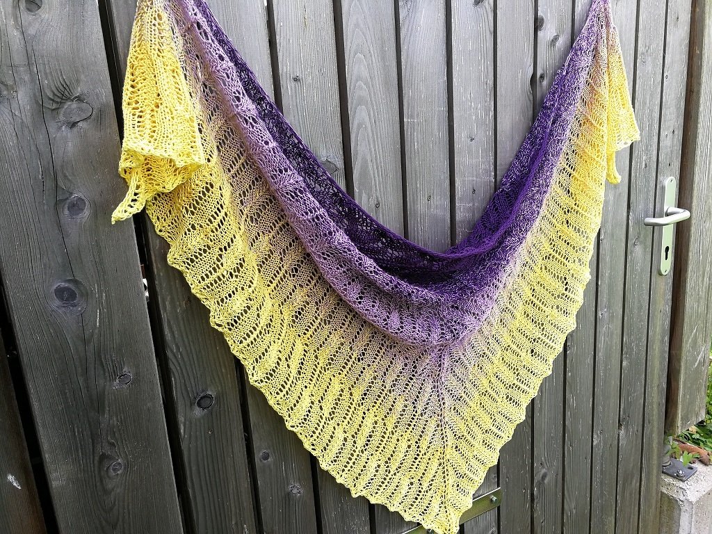 Gestricktes Dreieckstuch Gelb-Lila mit Lochmuster an Holztür