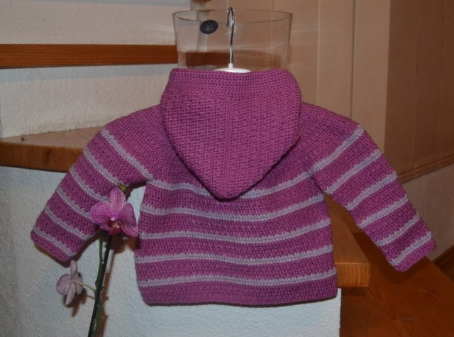 Rückansicht einer gehäkelten Baby-Kapuzenjacke in Violett mit hellgrauen Streifen