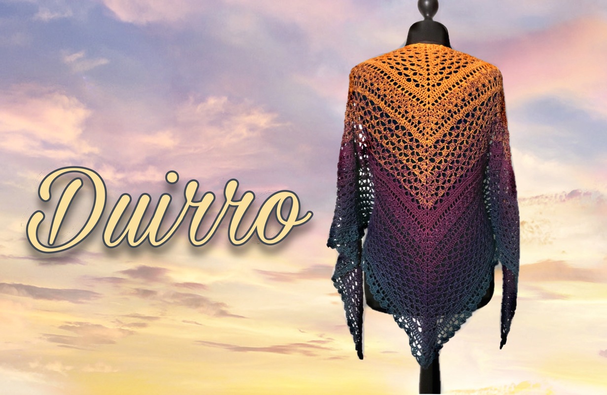 Crocheted triangle shawl with ombre orange, purple and blue-green gradient and openwork lace, shown on a mannequin.