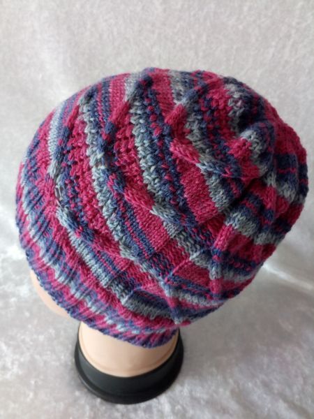 Gestrickte Damen-Strickmütze mit Streifen in Pink, Blau und Grau auf einem Kopfmodell