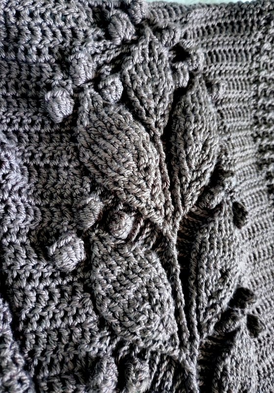 Gray crocheted jacket panel with raised leaf motifs and bobble stitches