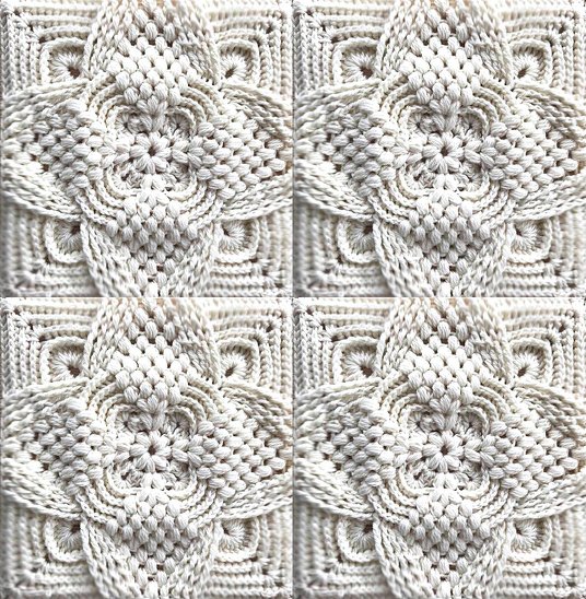 Nahaufnahme eines hellen gehäkelten Granny Squares mit erhabenem Blumen- oder Sternmuster