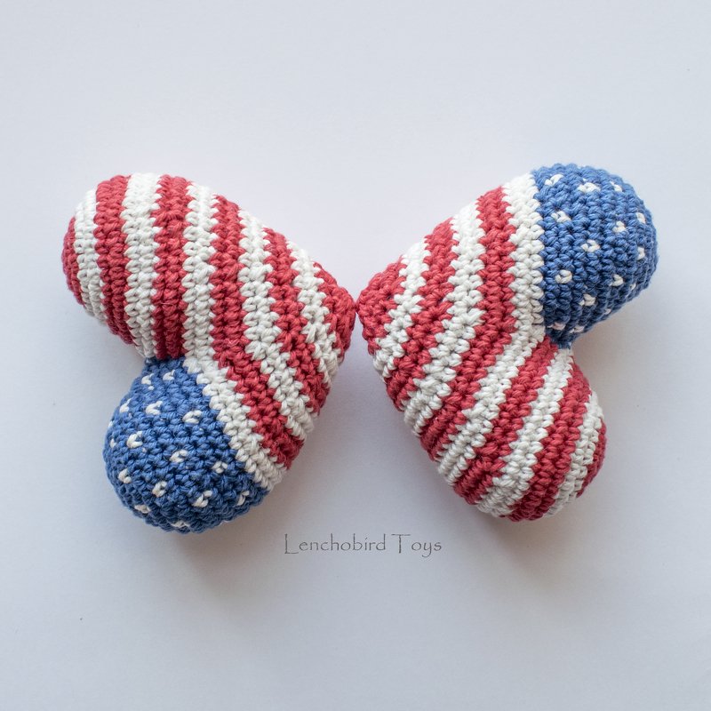 Pair of crocheted hearts with red and white stripes and blue dotted ends