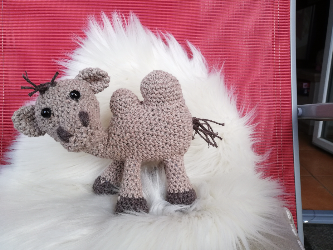 Gehäkeltes Amigurumi-Kamel, Detailansicht mit zwei Höckern, sichtbarer Maschenstruktur und dunklen Hufen
