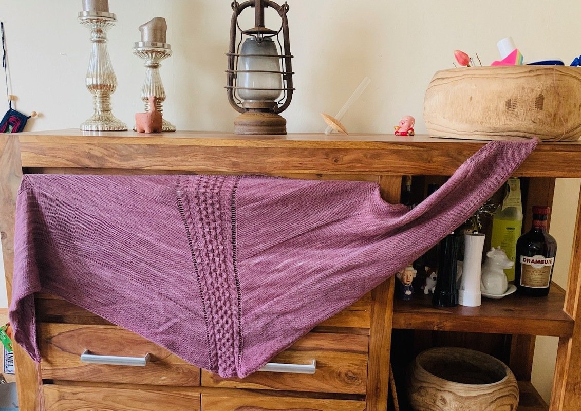 Gestricktes Dreieckstuch in Mauve mit mittigem Noppenstreifen, das Maschenbild ist deutlich zu sehen