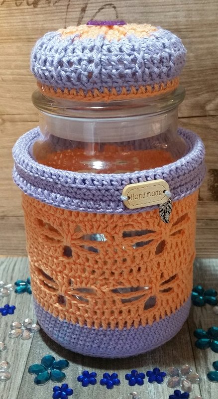 Glas mit zweifarbiger Häkelhülle in Orange und Lila, offenes Lochmuster und Häkeldeckel mit Holzanhänger 'Handmade'