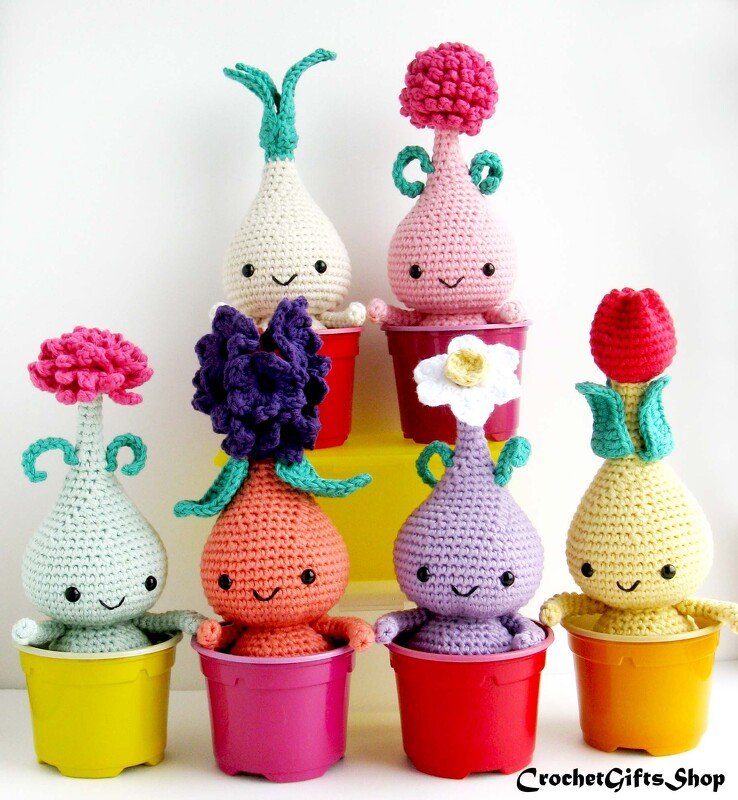 Colorful crocheted amigurumi plant dolls with smiling faces in small pots