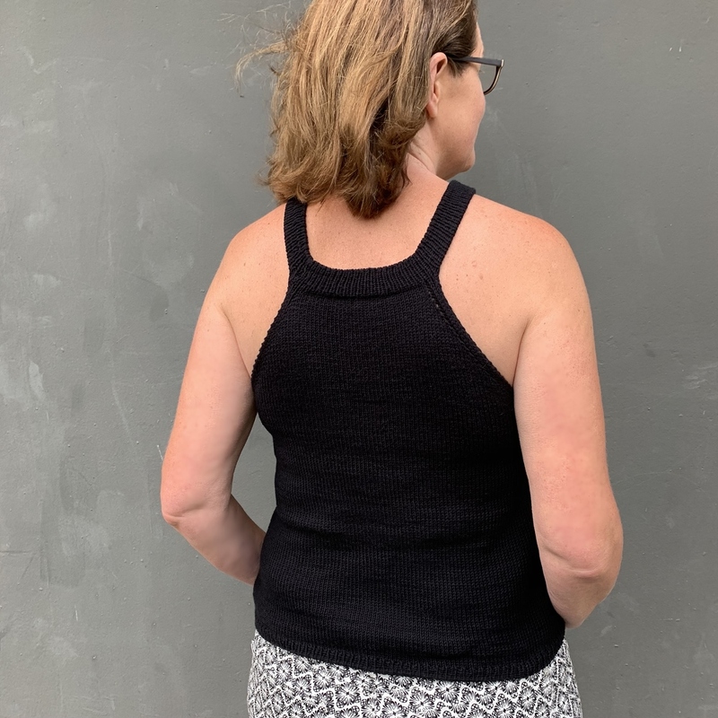 Rückenansicht eines schwarzen gestrickten Damen-Tops mit breiten Trägern