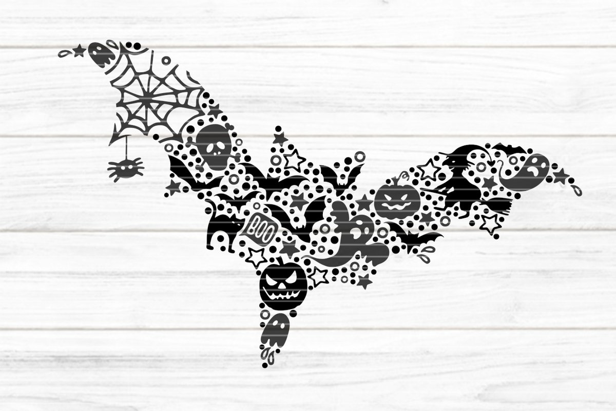 Schwarze Fledermaus-Silhouette aus Halloween-Symbolen auf hellem Holzuntergrund.