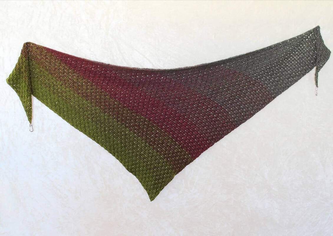 Crocheted triangle shawl with gradient from olive green to burgundy to charcoal grey.