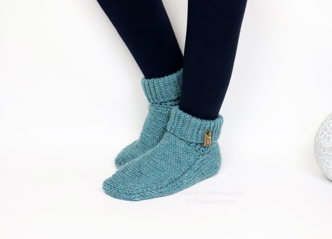 Teal crocheted ankle slipper socks with folded ribbed cuff and decorative toggle